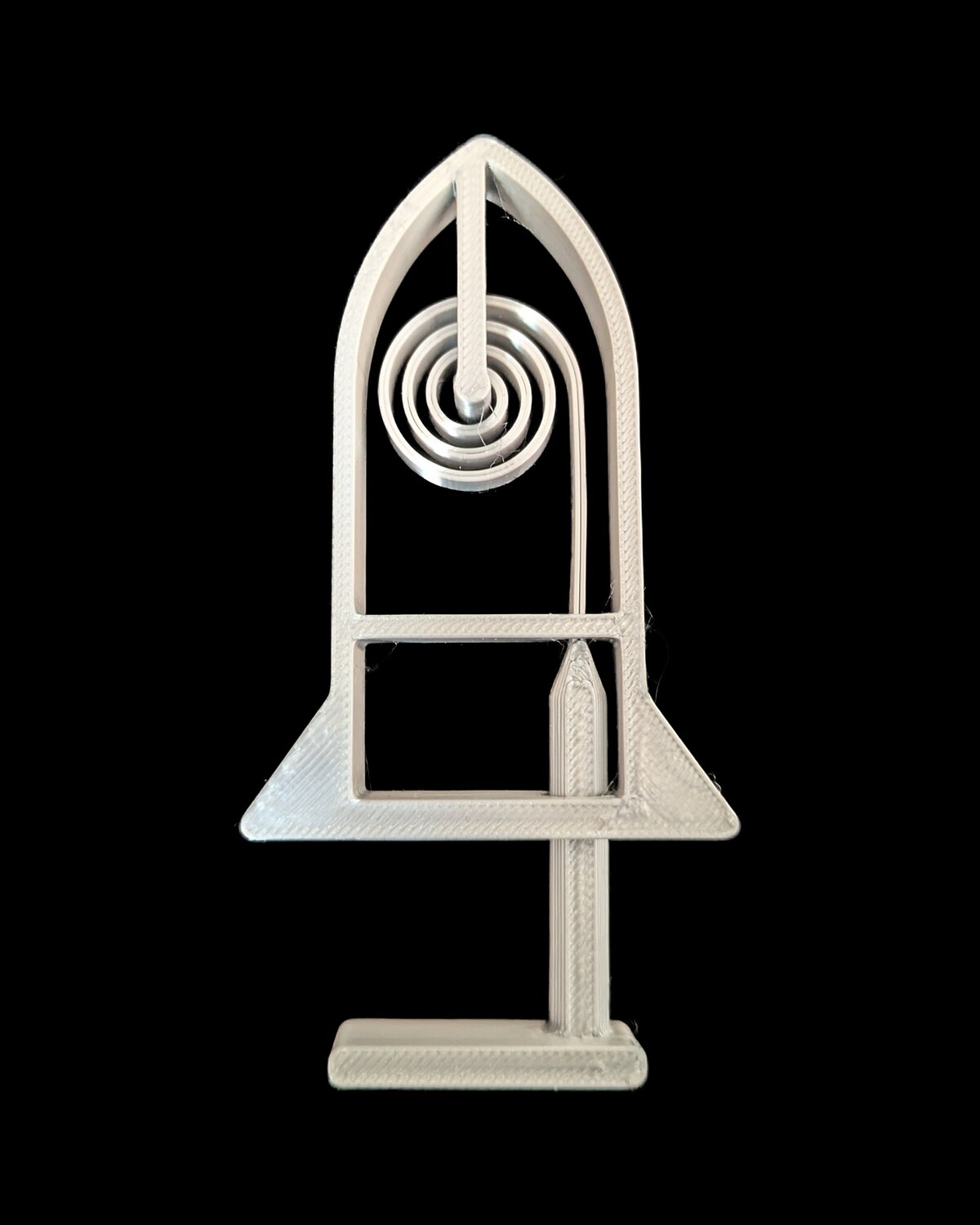Liftoff — a white printed rocket sitting on a coil spring inside its launcher